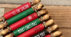 four christmas crackers are stacked on top of each other, with the words tis the season written on them