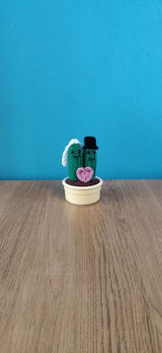 a small potted cactus sitting on top of a wooden table