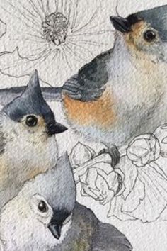 two birds sitting next to each other on top of a piece of paper with flowers