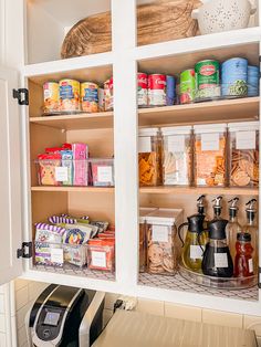 an organized pantry with lots of food and condiments on the shelves in it