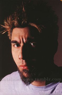 a close up of a person wearing a white t - shirt with hair on his head