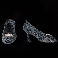 two pairs of shoes made out of plastic beads on a black background, with one shoe covered in water