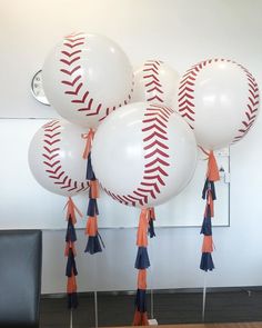 baseball balloons with tassels on them in an office