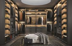 a large walk in closet with lots of clothes