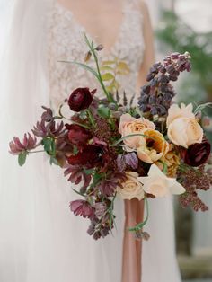 a woman in a wedding dress holding a bridal bouquet