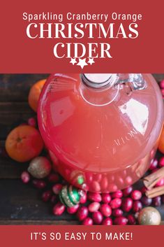 an orange christmas cider surrounded by cranberries and cinnamons with the title sparkling cranberry orange christmas cider it's so easy to make