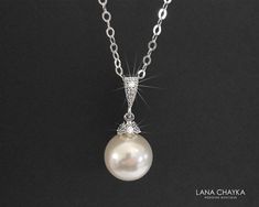 Wedding Swarovski 10mm White Pearl Drop 925 Sterling Silver Chain CZ Bridal Necklace. CHAIN is 18 inches (45.7 cm) long. PENDANT is about 1 inch (2.4 cm) long including bail. MATCHING EARRINGS: https://www.etsy.com/listing/95683858/white-pearl-drop-bridal-earrings?ref=shop_home_active_2 This necklace is made with 925 Sterling Silver chain, Swarovski 10mm White round crystal pearl, Rhodium Sterling Silver pearl component with clear Cubic Zirconia stones, and silver (Original Rhodium) plated bail Pearl Silver Necklace, Pearl Wedding Necklace, Bridal Pendant, Bridesmaids Jewelry, Bridal Pearl Necklace, Bridesmaid Pearls, Pearl Bridal Jewelry, Pearl Necklace Wedding, Bridal Earrings Drop