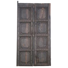 an old wooden door with iron bars on the front and side panels, isolated against a white background