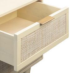 an open drawer on the side of a white cabinet with perforated doors and drawers