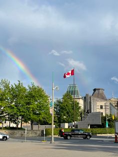 a rainbow in the sky over a city street