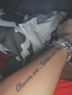 a person with a tattoo on their arm that says chosen one, and the other one