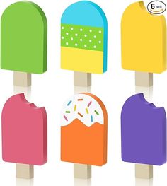 three popsicles with different colored toppings on them