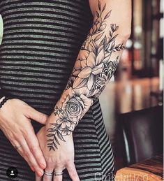 a woman's arm with flowers on it