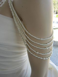 Shoulder Necklace Bridal shoulder necklace 2 pieces per order. 4 handcrafted pearl and brooch Shoulder Necklace Bridal shoulder necklace 2 pieces per order handcrafted beaded made to order Please get in touch for more information. Thank you so much for choosing my store. It is very importent to let my customers happy, so dont hesitate to contact me for your questions. Standart shipping I ship from Turkey , General delivery durations are USA : 12 /20 days Canada : 10/20days Australia: 15/25 days Off The Shoulder Dress Jewelry Necklaces, Pearl White Embellished Wedding Jewelry, Elegant White Body Jewelry For Evening, Elegant Body Jewelry For Formal Occasions, Elegant Formal Body Jewelry, Elegant White Pearl Chain Body Jewelry, Elegant White Body Jewelry With Pearl Chain, Beaded Silver Body Jewelry For Wedding, Elegant Pearl White Wedding Backdrop Necklace