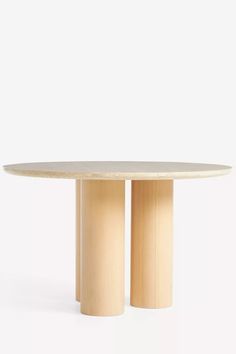 a round table with two columns on the top and one column at the base, against a white background