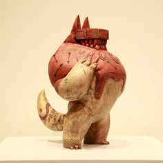 an elephant statue is on display with its trunk in the shape of a cat's head