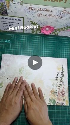 someone is making a mini booklet out of paper