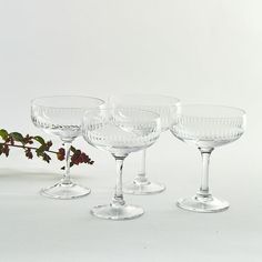 four wine glasses sitting next to each other