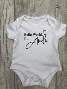 This baby vest is sized 0-3 months. In addition to name you choose from a heart or star in either pink, blue, metallic rose gold or black. Just add a message when ordering with name and detail required. Newborn Name Onesie, Baby Girl Cricut Onesies, Custom Name Cotton Top As A Gift, Personalized Fitted Pink Tops, Fitted Cotton Top For Gender Reveal, White Fitted Top For Gender Reveal, Baby Girl Cricut Ideas, Baby Girl Onesie Ideas, Cricut Baby Projects