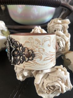 "🔸🔸orders are delayed by a few days this week. Thank you for your patience Country leather bracelet cuff, western jewelry Embossed distressed genuine white leather 1 1/2\" strap has been adorned with a round southwestern silver concho which sets on a detailed antiqued silver flower filigree and a copper filigree and is attached to the leather with two antiqued copper rivets. One antiqued copper snap has been placed to fit up to a 6 3/4\" wrist. I can add another snap if you would like a smalle Bohemian Hand Tooled Jewelry For Rodeo, Adjustable Western Cuff Bracelet With Patina, Vintage Concho Leather Bracelet For Festival, Adjustable Western Cuff Bracelet For Festivals, Adjustable Western Style Cuff Bracelet For Festivals, Vintage Leather Concho Bracelet For Festival, Western Style Adjustable Cuff Bracelet For Festivals, Adjustable Western Style Festival Cuff Bracelet, Southwestern Leather Concho Cuff Bracelet