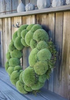 a wreath is hanging on the side of a wooden wall