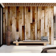 a living room with wood paneled walls and white flooring on the wall, along with a couch