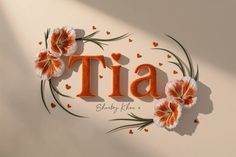 an orange and white wall with the word tia written in cursive font surrounded by flowers