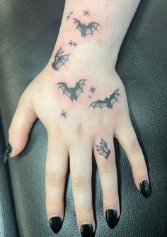 a woman's hand with bats on it