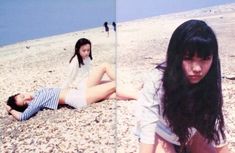 two women sitting on the beach next to each other and one woman laying on the ground