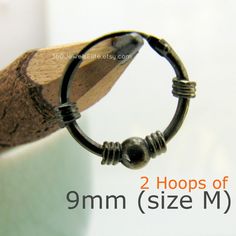 a close up of a pencil with the words 2 hoops of 9mm size m