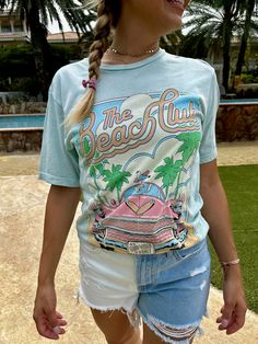 This Lotus Boyfriend Graphic Tee is the perfect laid-back look. Loose in all the right places, its open neckline and slightly dropped sleeves make it ideal for your beach days. With a Mineral Wash and a hand-drawn exclusive graphic, this tee is sure to be your new summer fave! Go get 'em, beach babe! Color: Mint or Light Pink Fabric: 100% Cotton Brand: Lotus Fashion Collection Made: El Salvador Includes: x1 Graphic T-Shirt Sizes: S-XL, Regular Sizing Light Pink Fabric, The Beach Club, All The Right Places, Beach Babe, Pink Fabric, Beach Days, Beach Club, Shirt Price, Beach Day