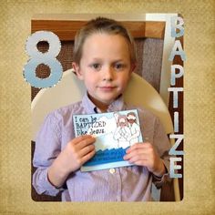 a young boy sitting in a chair holding a card