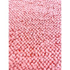 a close up view of a pink rug with small dots on the top and bottom