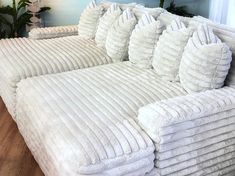 a large white couch sitting on top of a hard wood floor