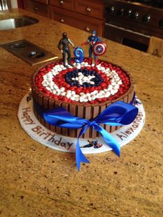 a birthday cake with captain america decorations on it