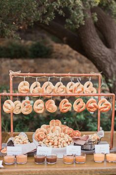 a table topped with lots of doughnuts and other food on top of it