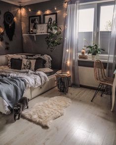 a bed room with a neatly made bed next to a window and a desk in front of it