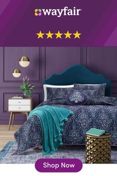 a bedroom with purple walls and blue bedding