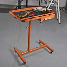 an orange work table with tools on it