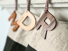 two wooden ornaments hanging from the side of a wall