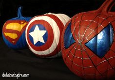 two pumpkins made to look like captain america and spider - man are sitting side by side