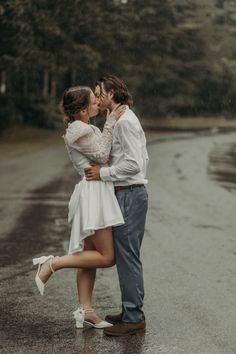 a man and woman kissing in the rain