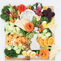 an assortment of fruits and vegetables on a cutting board