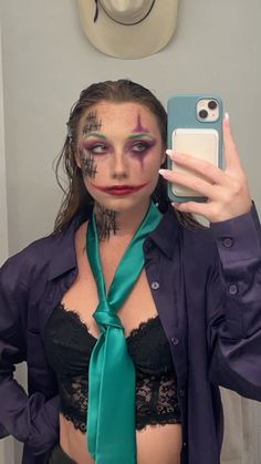 a woman with makeup is taking a selfie