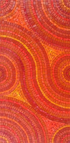 an orange and red mosaic tile pattern with circles on the bottom, as well as dots in the middle