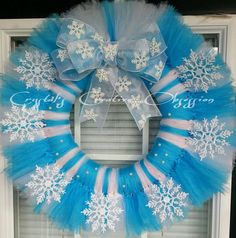 a blue and white wreath with snowflakes on it