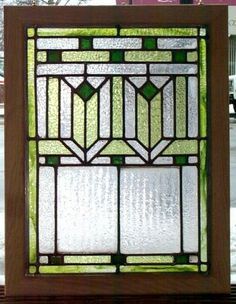 a stained glass window sitting on top of a wooden frame