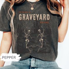 a woman wearing a t - shirt that says i was a graveyard crash