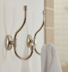 an image of a towel rack with two hooks on the wall and one hook attached to it