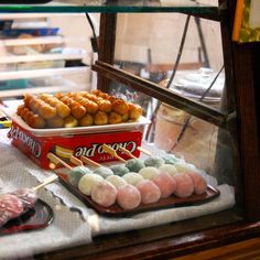 an assortment of food on display in a store window